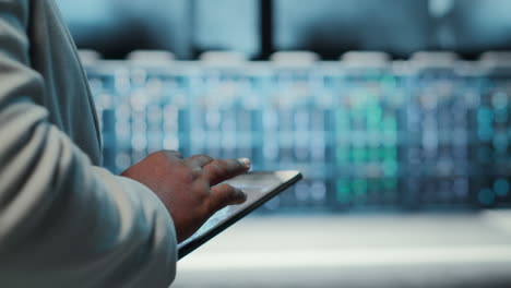vertical video manager walking in server hub using tablet to find firewall misconfigurations