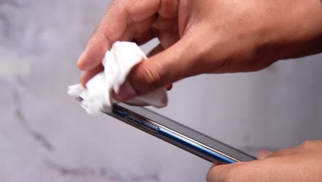 cleaning a smartphone with a tissue