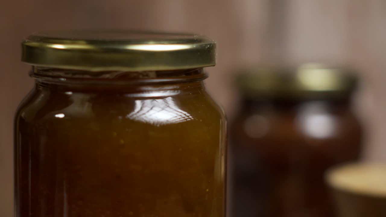 Very close up of rotating jar of peach jam