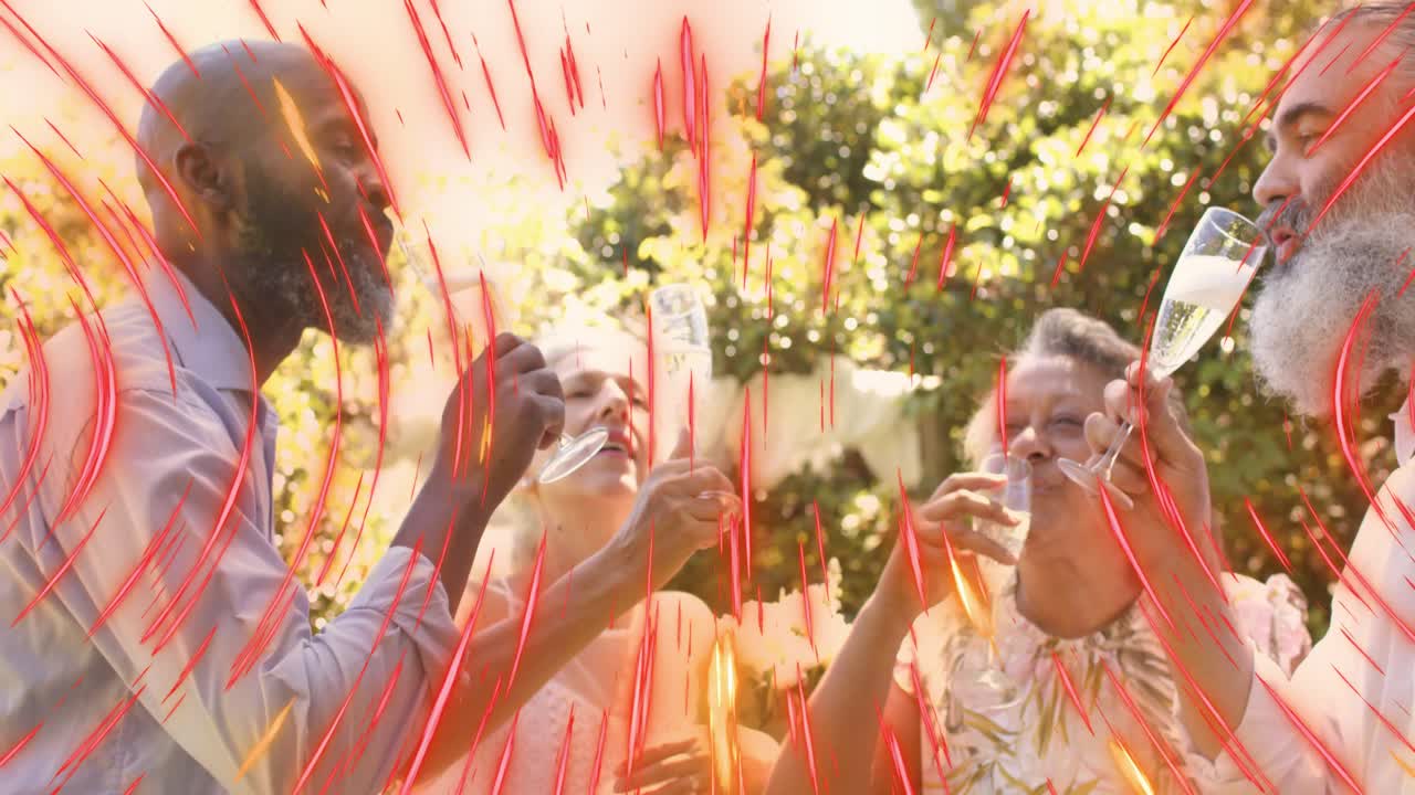 Four adults raising flutes, toasting, sipping in garden while red streaking across scene for events