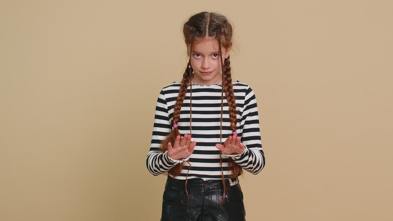 Strict child girl kid warning hands gesture saying no be careful advice to avoid danger caution