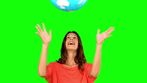 Woman-throwing-a-globe-on-green-screen