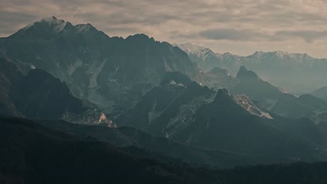 aerial circling right orbit of carrara, italy, rolling hills and distant mountains in golden evening light with stunning ridgelines