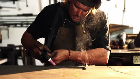 welder using welding torch