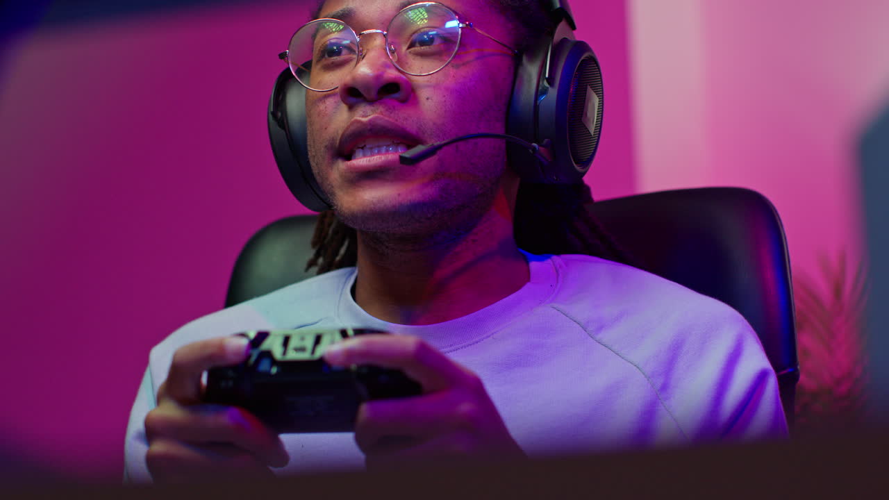 Man playing video game with a headset and controller