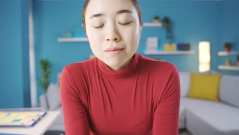 asian woman thoughtfully looking around and at camera.