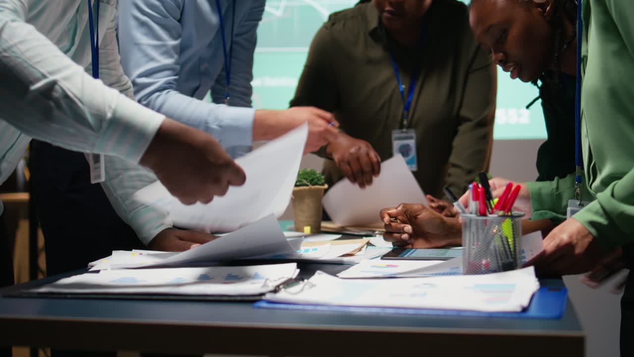 Business consultants team meeting after hours to review diagrams