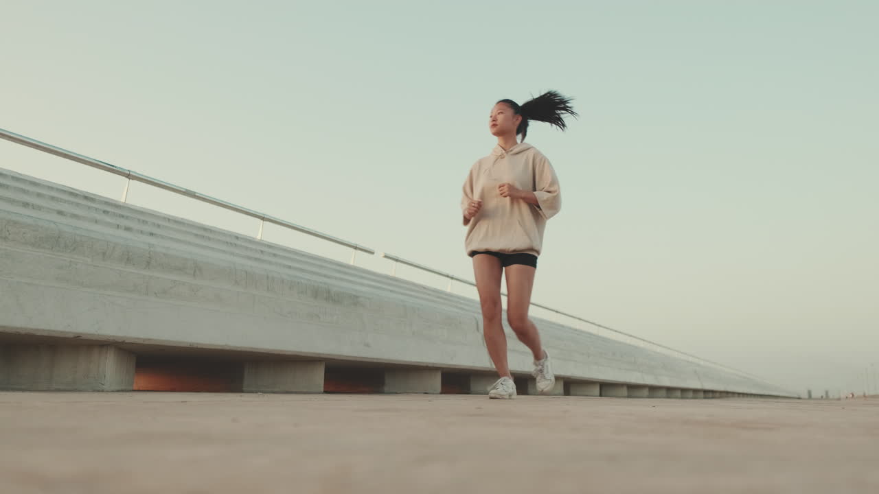 Woman Running on Bridge