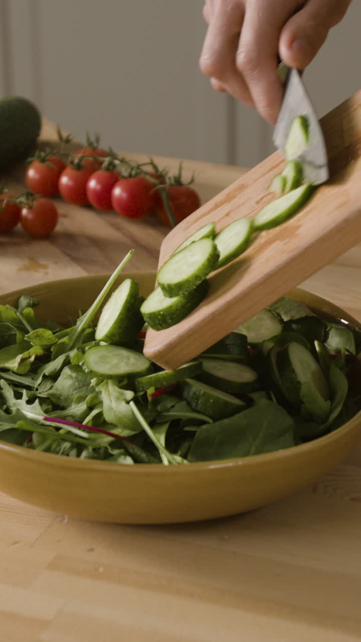 Preparing a healthy salad with cucumber and tomatoes