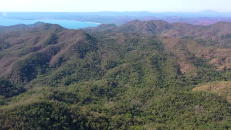 Stunning-aerial-view-of-mountains-and-blue-ocean-in-Mexico