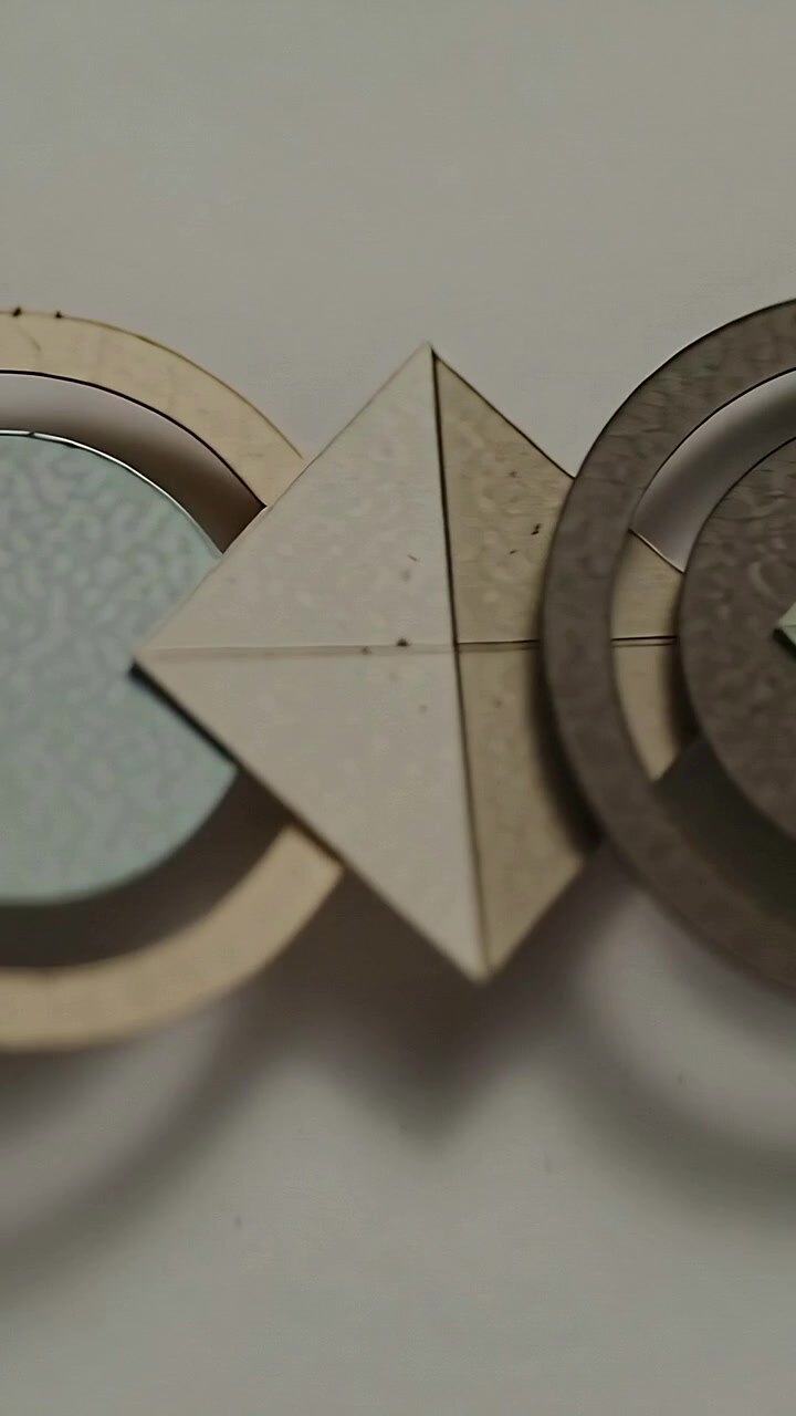 Vertical video: Panning by camera geometric ornament at home, revealing rings discs diamond motifs