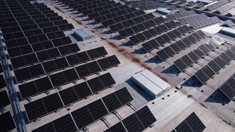 solar panels installed on a roof of a large industrial building or a warehouse. industrial buildings in the background. horizontal photo.