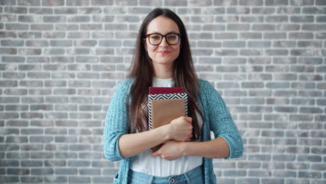 woman holding books, smiling