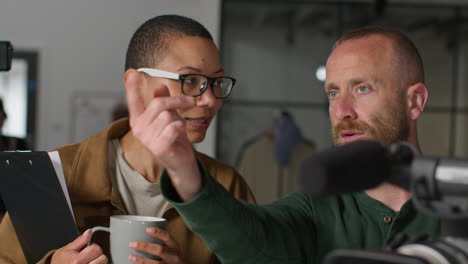 a woman and man discuss filming plans on a film set