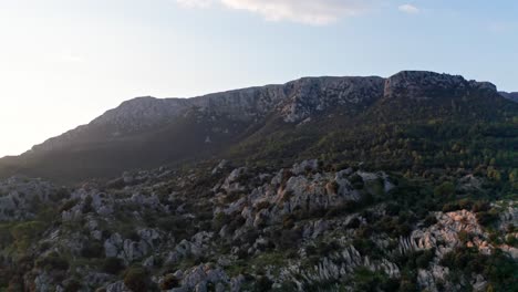 Stony-dark-mountain-landscape-with-rocks-and-dry-vegetation,-drone-aerial-view