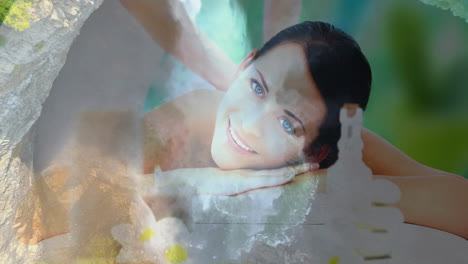 mujer sonriente recibiendo masaje sobre escena de naturaleza serena con cascadas