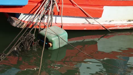 colorful boat tied to a dock, bobbing slightly