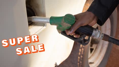 animation of super sale text over hand of man filling truck with fuel pump at petrol station