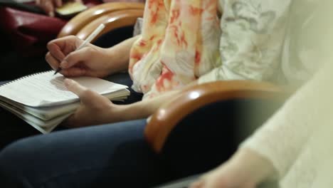 listener hand writes during training. close-up of listener hand writes on sheet during training