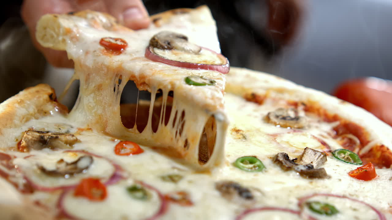 Delicious cheesy pizza with mushrooms and peppers