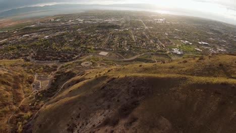 Aerial-view-of-a-busy-canyon-highway-in-Provo,-Utah,-located-in-the-Rocky-Mountains,-on-a-bright-winter-afternoon