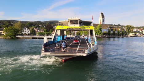 close aerial drone shot of car ferry meilen loading cars on lake zürich in switzerland