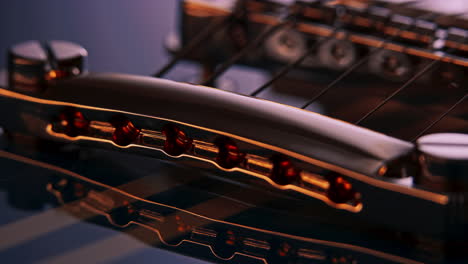 extreme close up product shot of a guitar bridge tailstop