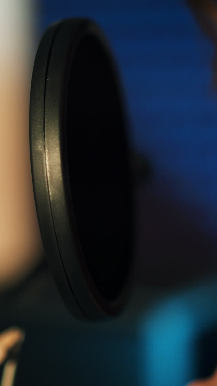 Woman singing in a recording studio. Female vocals. Professional recording studio. Vertical video