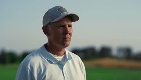 professional golf player enjoy course country club. golfing coach looking away.