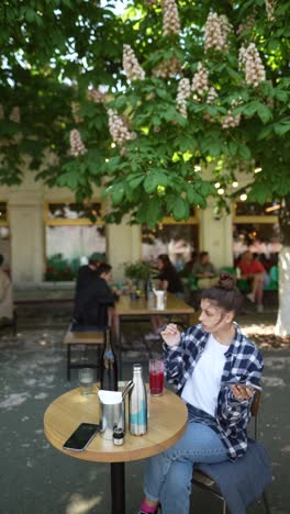 woman relaxing in an outdoor cafe