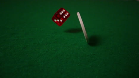 white chip spinning and red dice falling on casino table