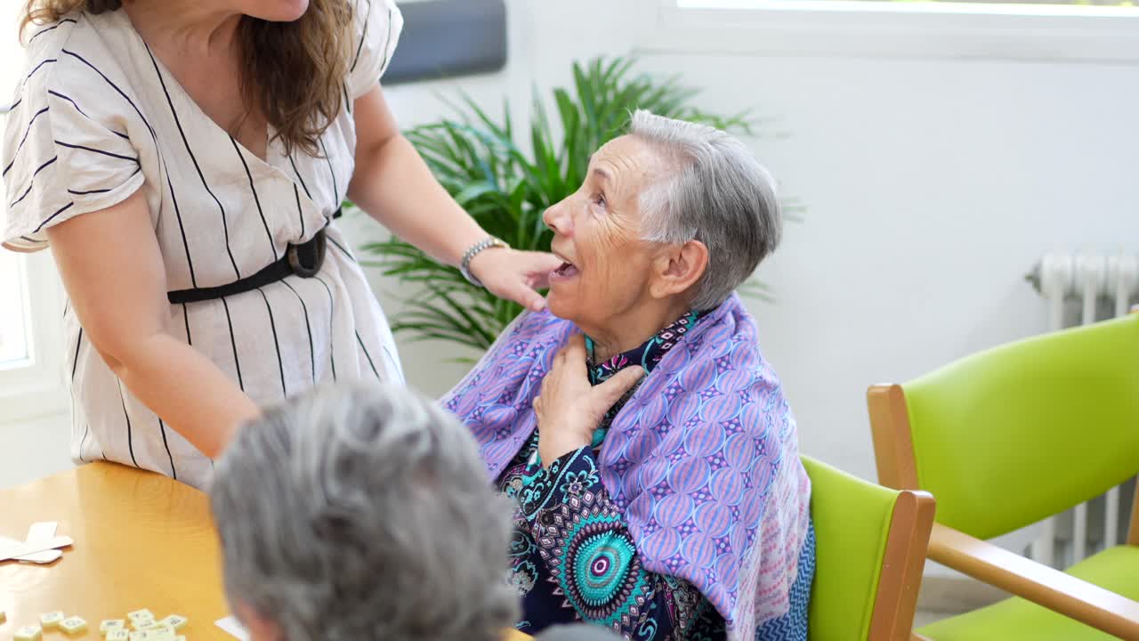 Elderly Woman with Caregiver Playing Scrabble