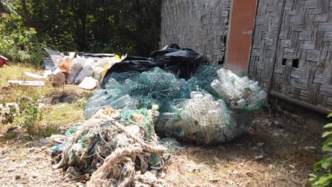 collected behind a traditional andaman island home near the beach a pile of segregated beach cleanup waste ready for collection - the plastic goes to port blair for recycling into road materials