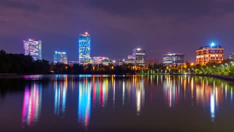 city skyline night time lapse loop, bucharest romania office buildings at night