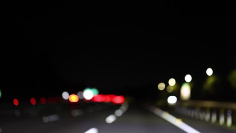 out-of-focus lights moving on a dark highway