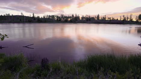 colorful panoramic sunset over a small lake in the mountains of utah