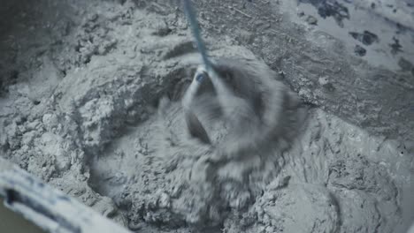 mixing and preparing concrete with vigor: a sequential display of texture and consistency in a heavy-duty mixing container
