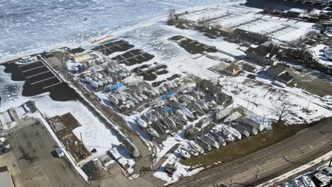 sailboats docked for winter on the shore of muskegon lake