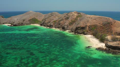 the white sand beach of tanjung aan in lombok, indonesia during a sunny day