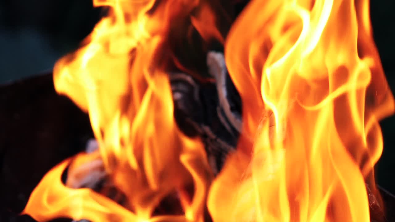 Burning wood, campfire macro video. Hot fireplace full of wood. Slow motion