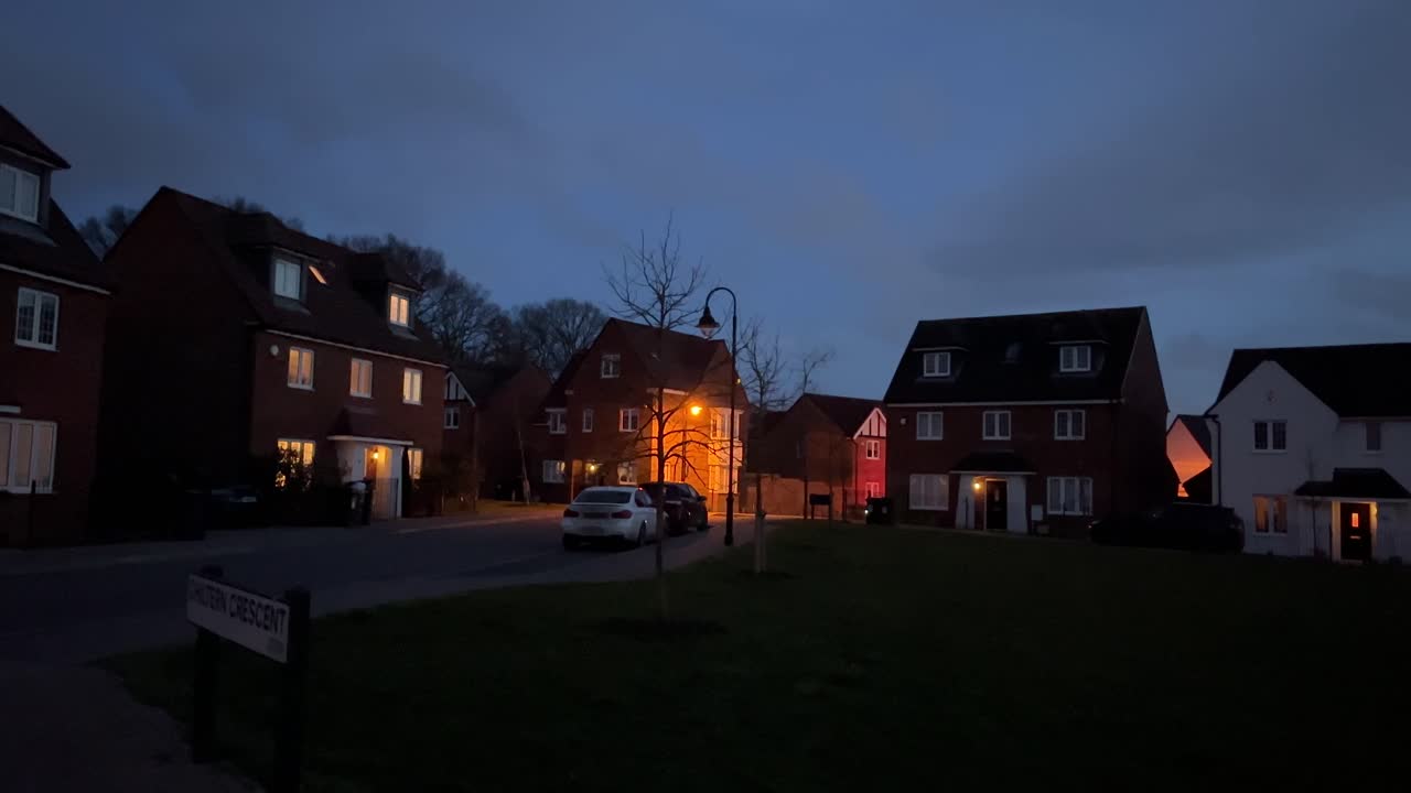 slow pan around shot of a housing estate in england just after the sun set and it started to get darker as the night got closer