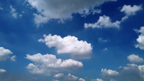 white puffy clouds and blue sky time-lapse with long second duration for background and graphics in daylight