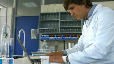 scientist checking prescription and using laptop