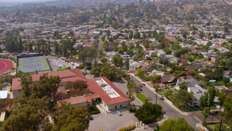 flyover eagle rock neighborhood in los angeles, california on a sunny summer day with houses, streets, and occidental college campus tennis courts