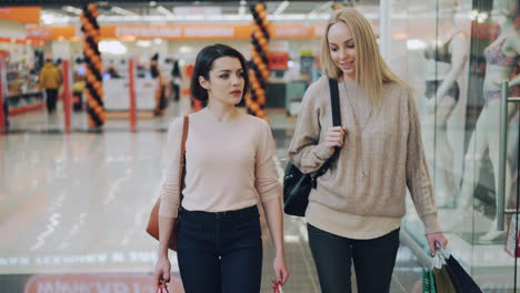 two women shopping in a mall