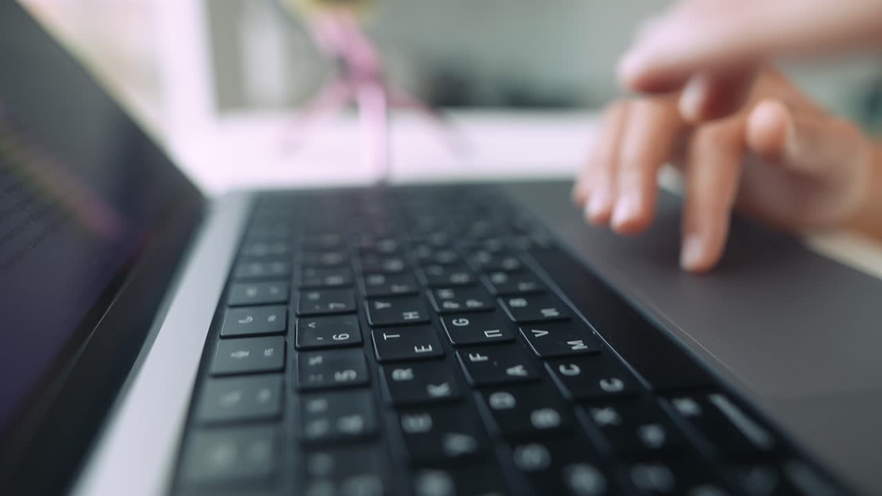 Close Up of Hands Typing and Using Trackpad on Laptop