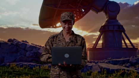 Asian Man Soldier Using A Laptop While Standing With Satellite Dish