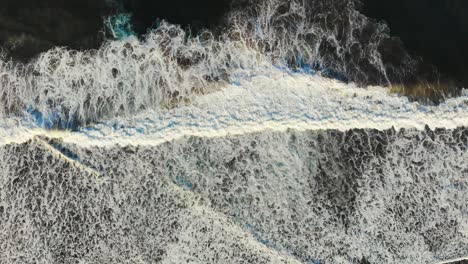 Breaking ocean waves from above, perfect symmetry in nature