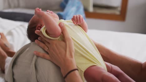 video of newborn baby holding by mum and crying