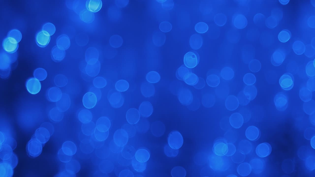 Panorama. Beautiful reflection of defocused lights in the water. Defocused abstract blue Christmas background.